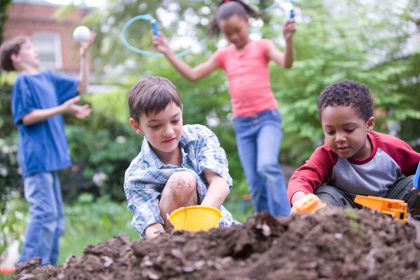 Four children playing outside in a backyard dirt pile, enjoying the fresh air, physical activity, and interacting as friends.. Courtesy of the Public Health Image Library, Centers for Disease Control and Prevention.